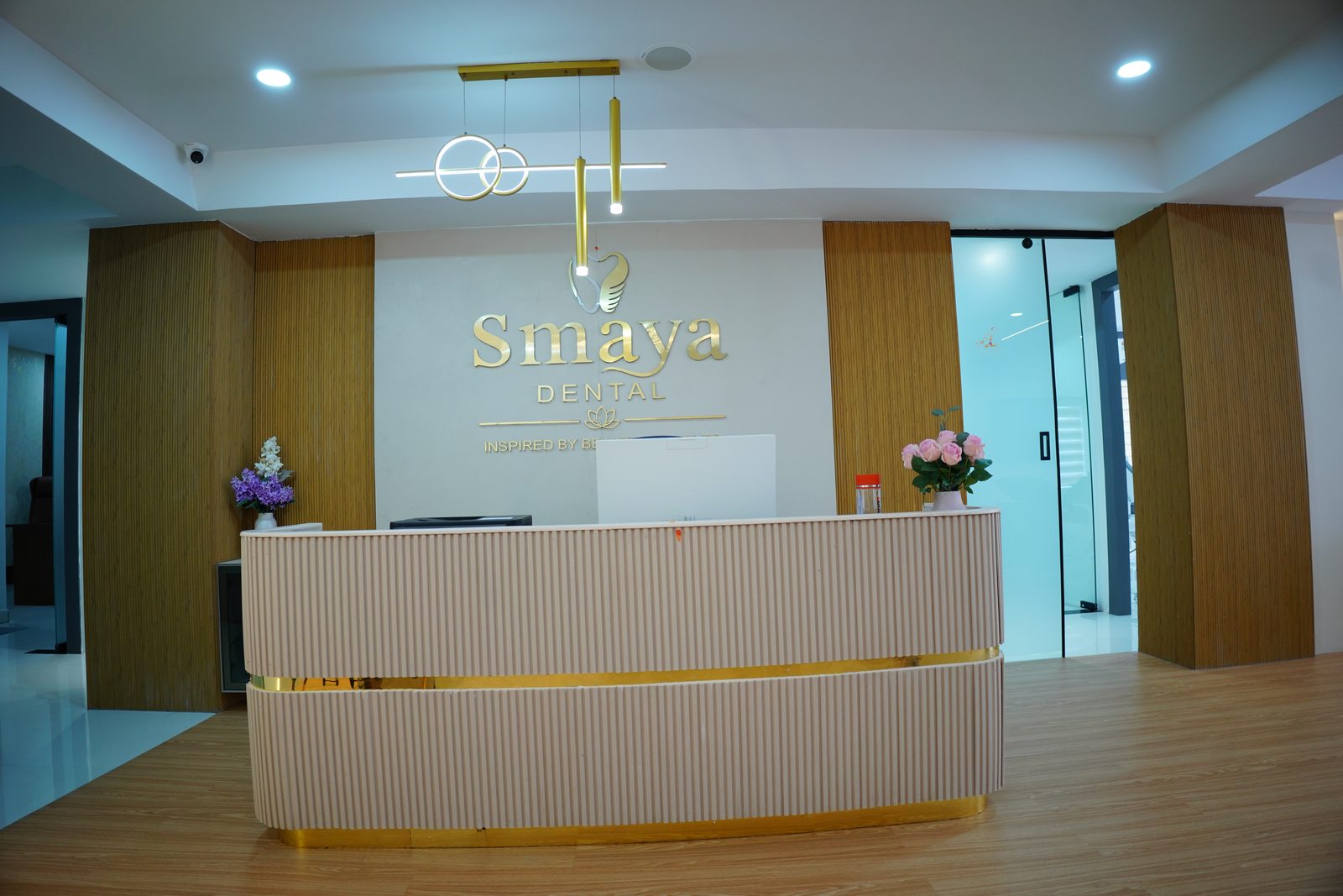 SMAYA DENTAL Luxury Reception Desk with Golden Logo and Drop Pendants in Kondapur